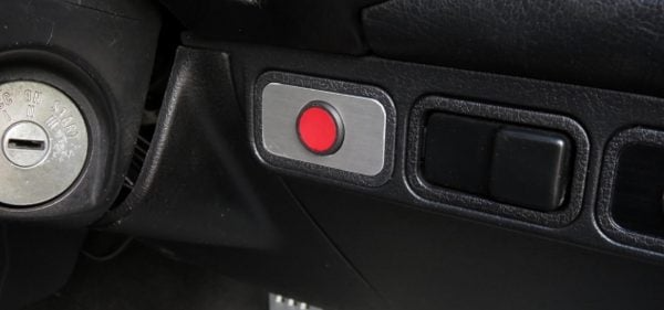 Example red panic button installed within easy reach of the driver.